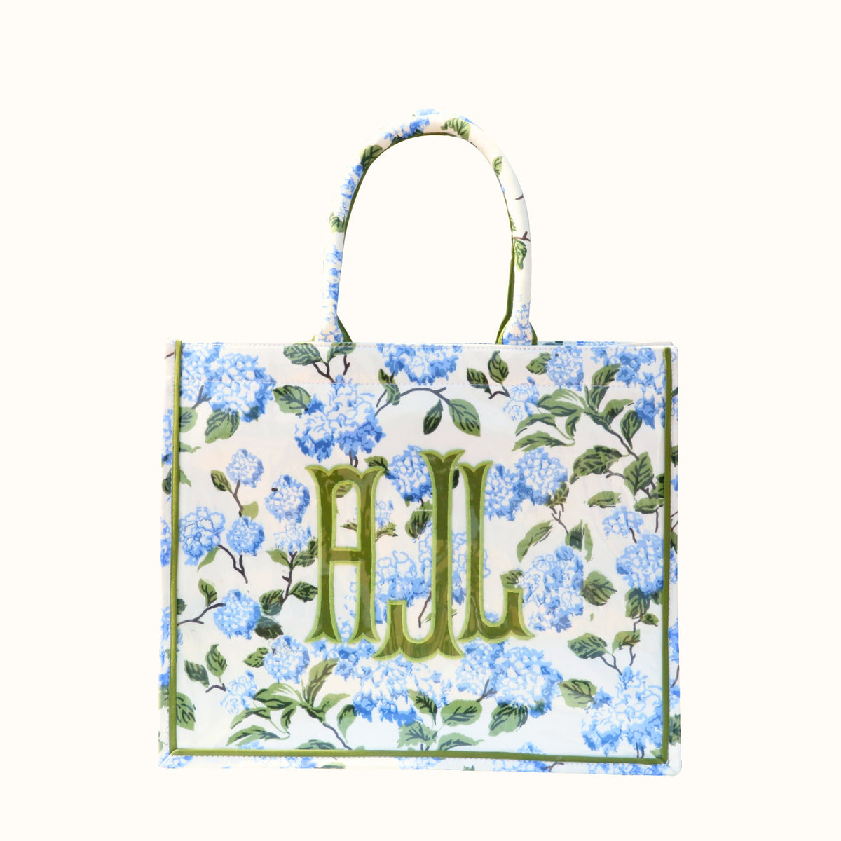 Custom monogram blue hydrangea tote bag with green embroidered initials and floral pattern.