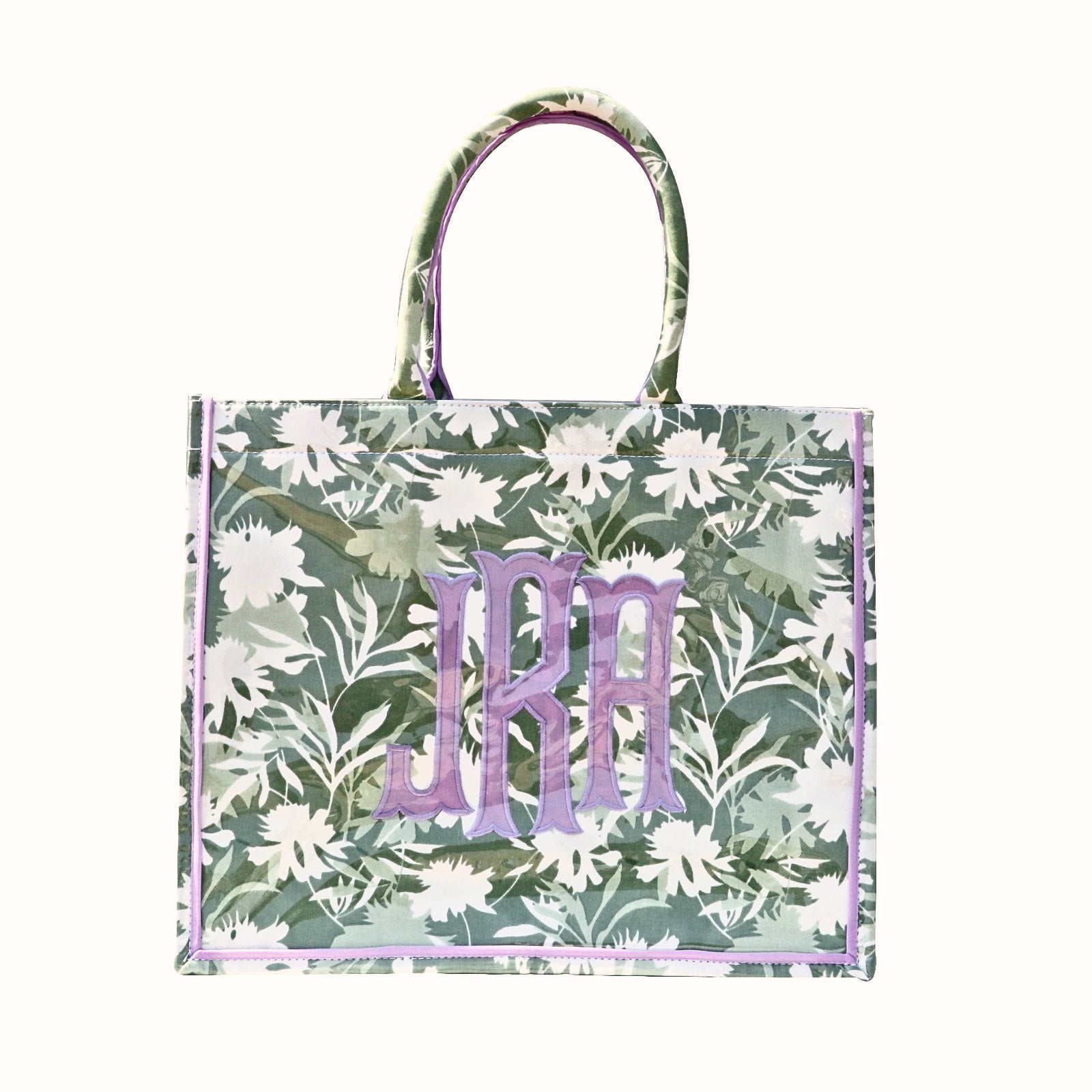 Sage green floral tote bag with purple monogram and trim, featuring white flower patterns.