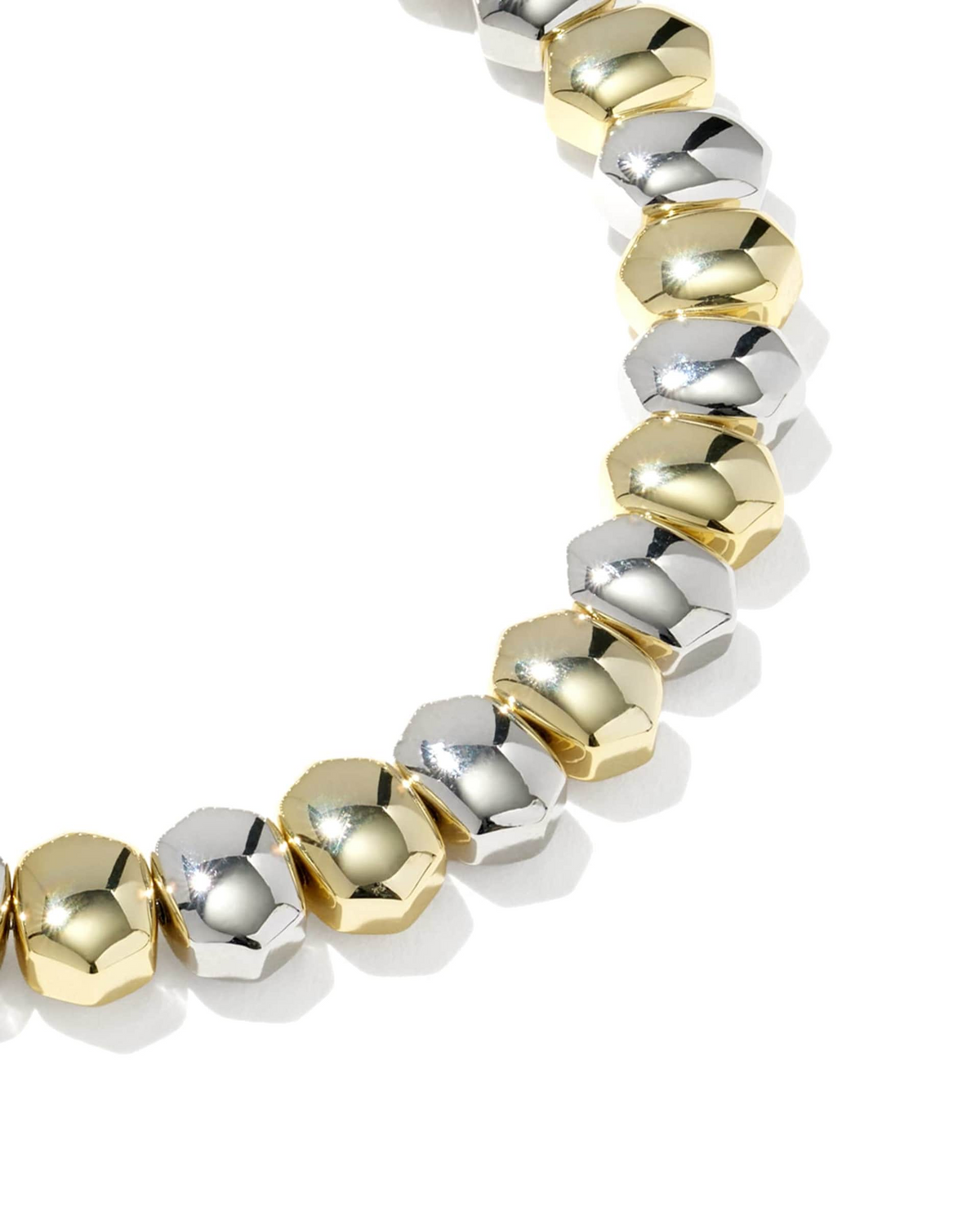 Close-up of a Daphne Stretch Bracelet featuring alternating gold and silver faceted metal beads.
