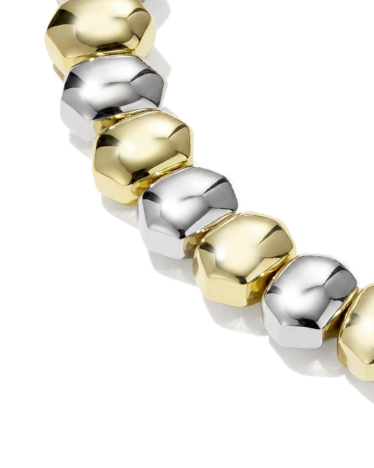 Close-up of the Daphne Stretch Bracelet featuring alternating gold and silver faceted metal beads.
