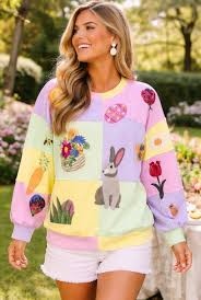 Pastel pink and yellow colorblock sweatshirt featuring a white Easter icon graphic on the chest.