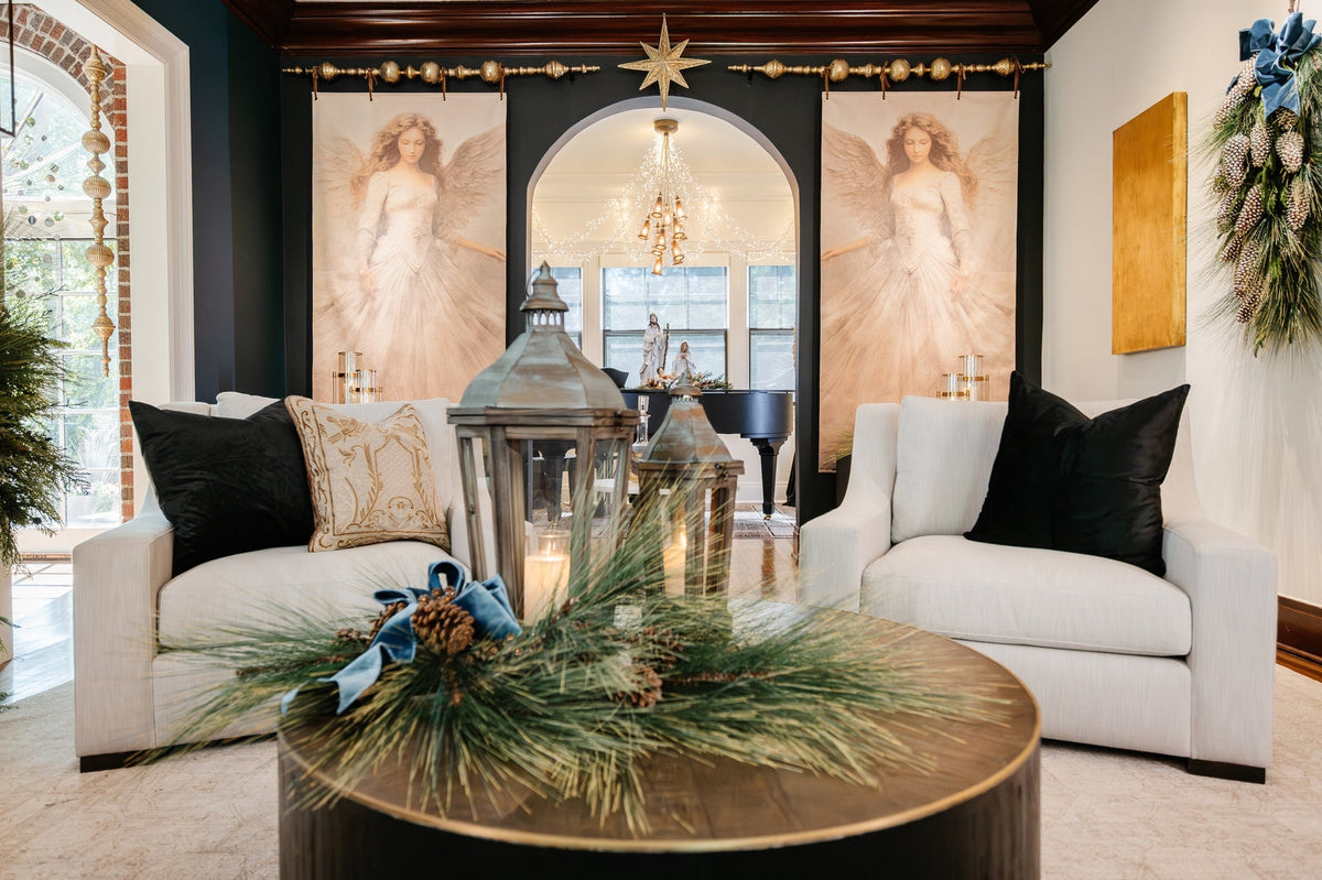 Left Angel Canvas Scroll hanging on a dark wall in a festive living room setting.