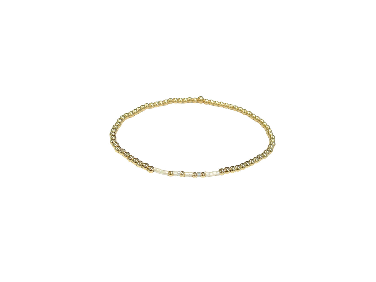 Faith bracelet with pearl and cream glass beads in a neutral pattern on elastic cord