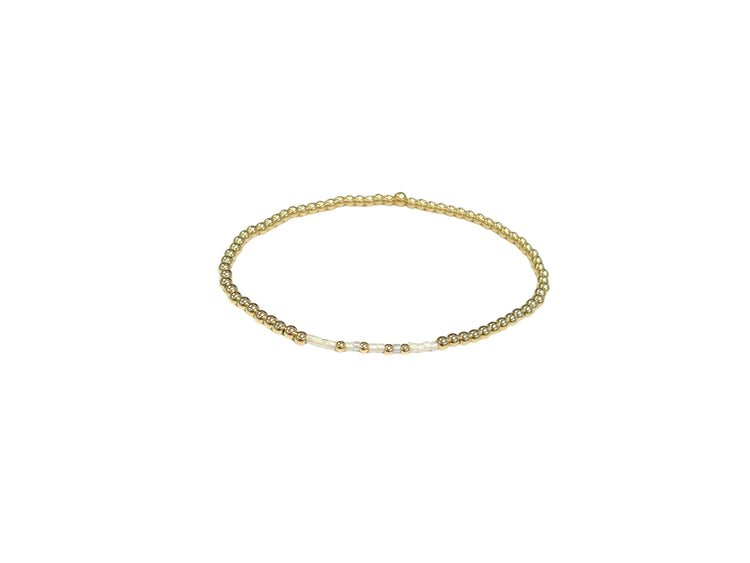Faith bracelet with pearl and cream glass beads in a neutral pattern on elastic cord