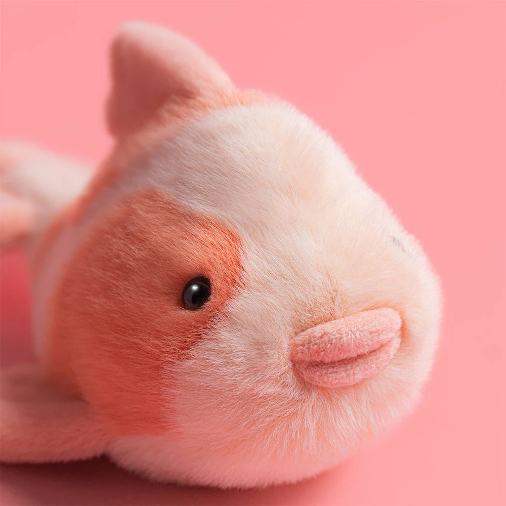 Close-up of a Jellycat Fancy Carp plush toy with orange and white fur and a small pink mouth.