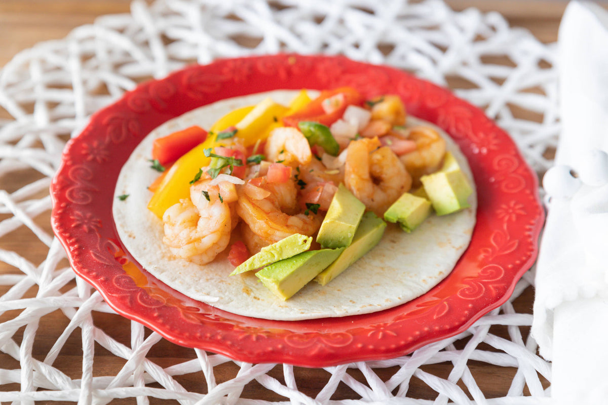 Firecracker Shrimp Fajitas meal kit with corn tortillas in a clear package.