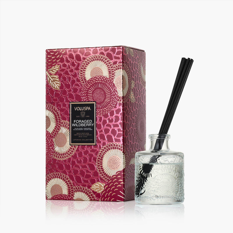 Voluspa Foraged Wildberry reed diffuser in an embossed glass bottle with black reeds and gift box.