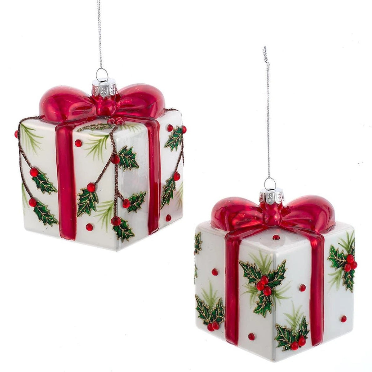 Two white glass present ornaments with red bows and holly leaf and berry decorations.