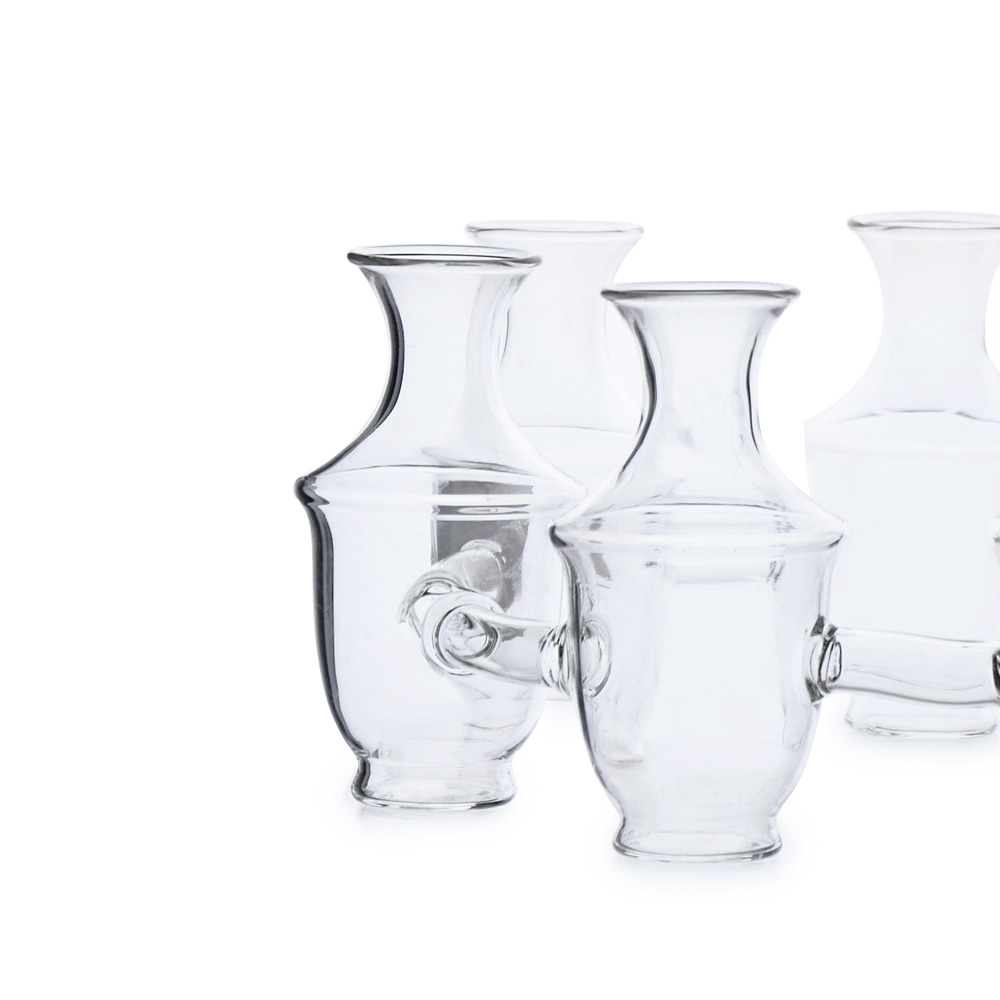 Handblown clear glass vase with a flared rim and curved silhouette, shown in a group.