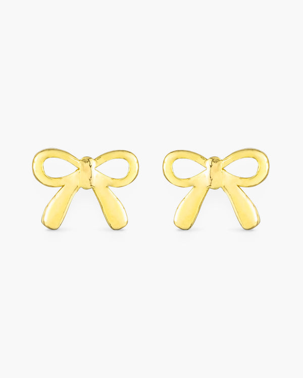 A pair of gold bow ribbon stud earrings on a white background.