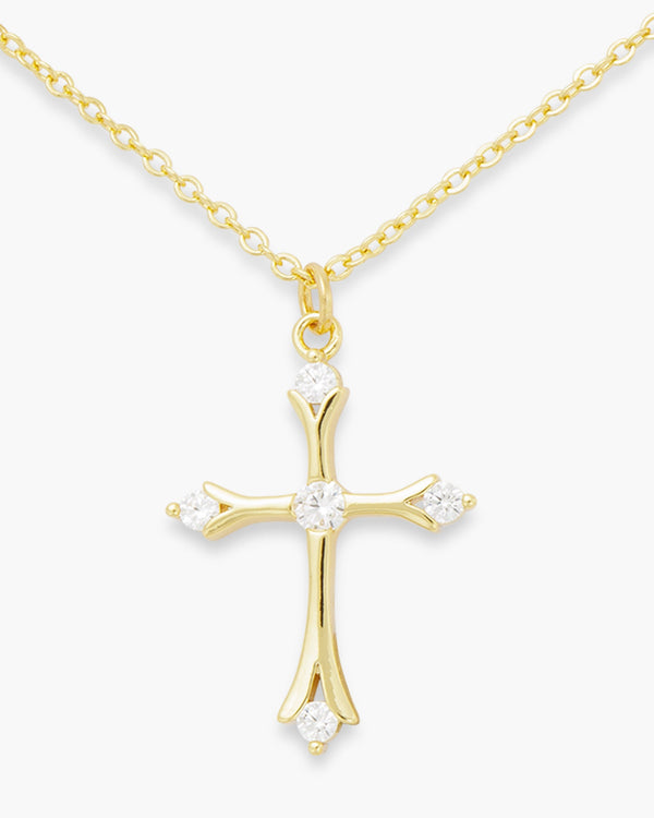 Gold chain necklace with a cross pendant featuring five clear cubic zirconia stones.