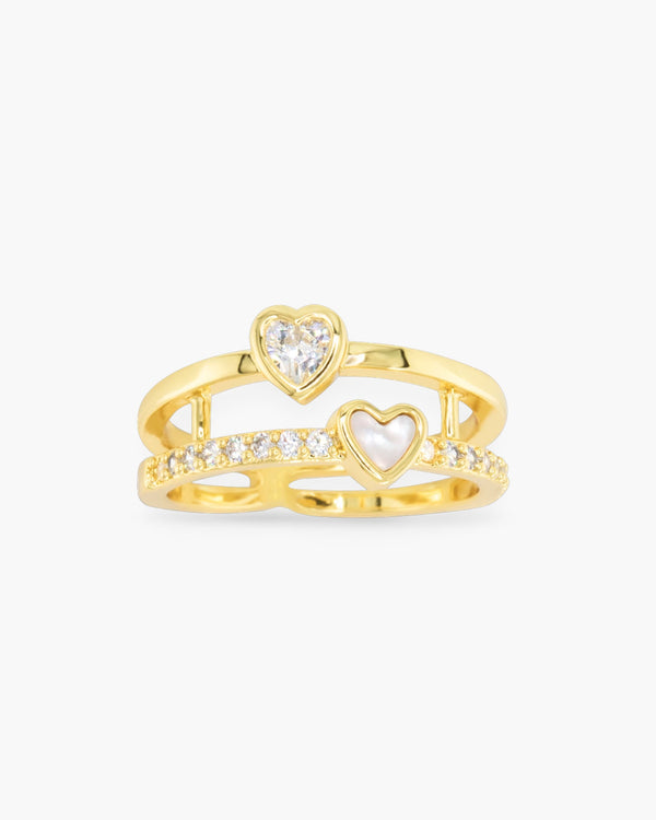 Gold stack ring featuring two bands with a CZ heart and a mother of pearl heart.
