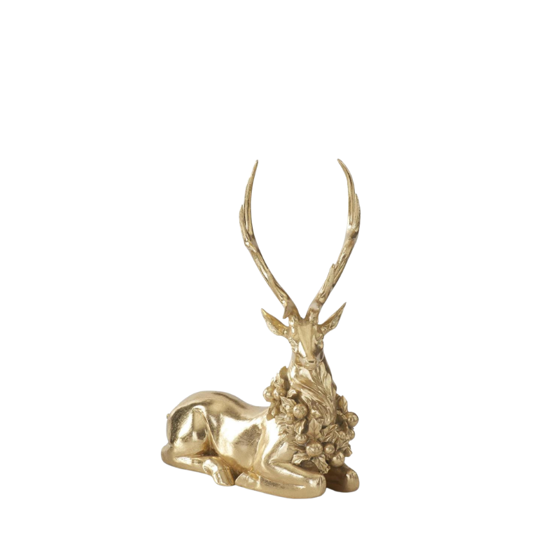 Gold resin resting deer figurine with graceful antlers and a green holiday wreath around its neck.