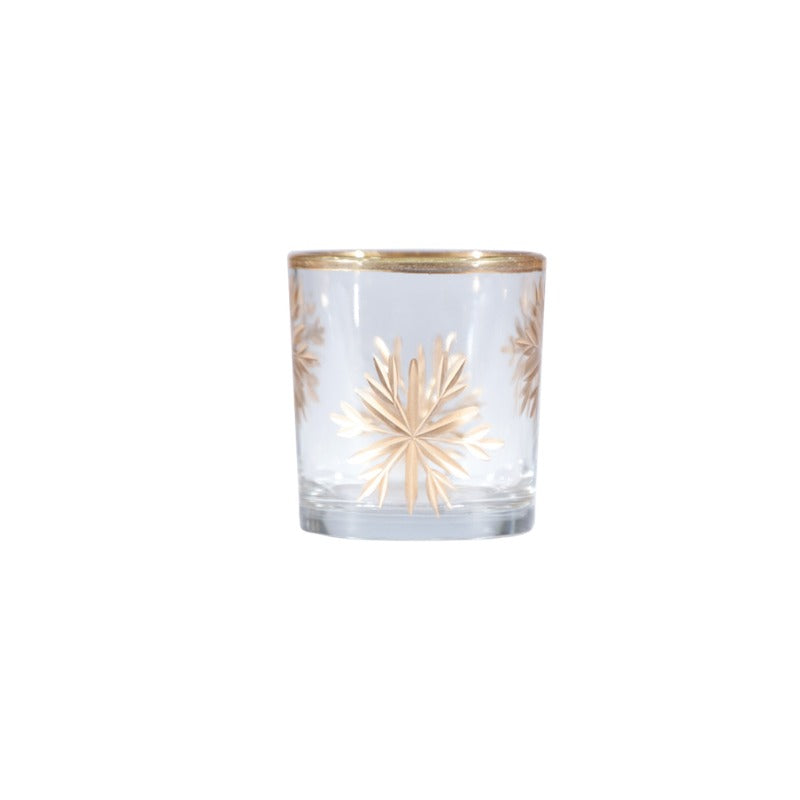 Hand-painted etched glass votive holder with a gold snowflake design and gold rim.