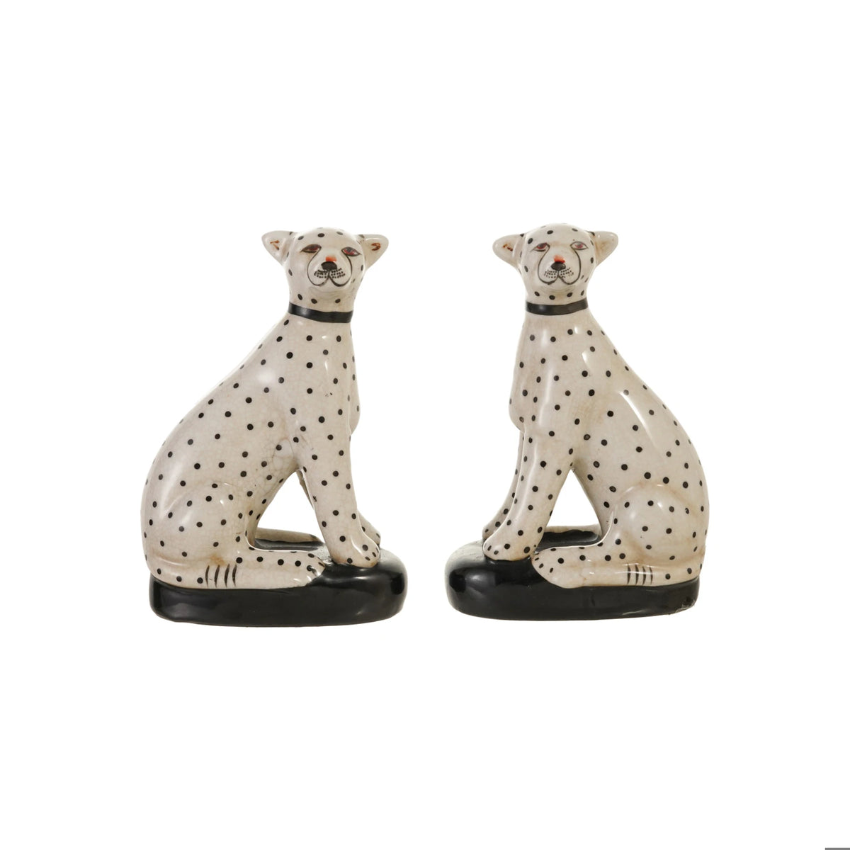 Set of two hand-painted white stoneware cheetah figurines with black spots on black bases.