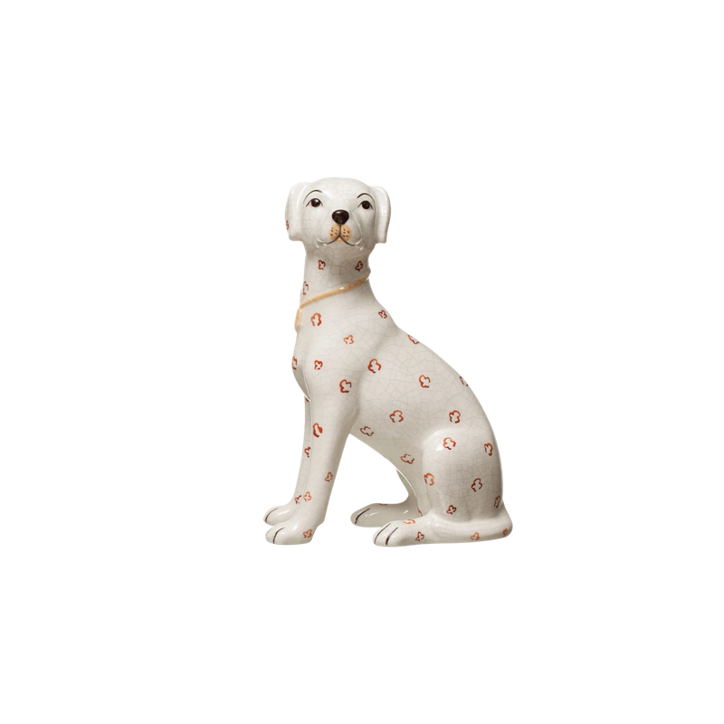 Hand-painted ceramic dog figurine with a white crackle glaze and orange floral patterns.