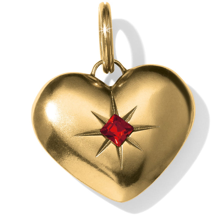 Gold plated heart-shaped amulet featuring a central red square gemstone in a starburst setting.