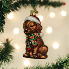 Holiday Chocolate Labrador Pup glass ornament wearing a Santa hat and a festive scarf.