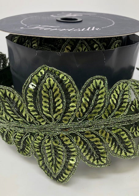 4 inch wide olive green Masquerade Vine ribbon with sequined leaf patterns on a spool.