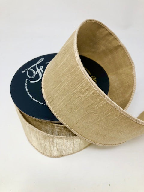 2.5 inch by 10 yard Dupion Beige Ribbon with a textured finish and wired edges on a spool.