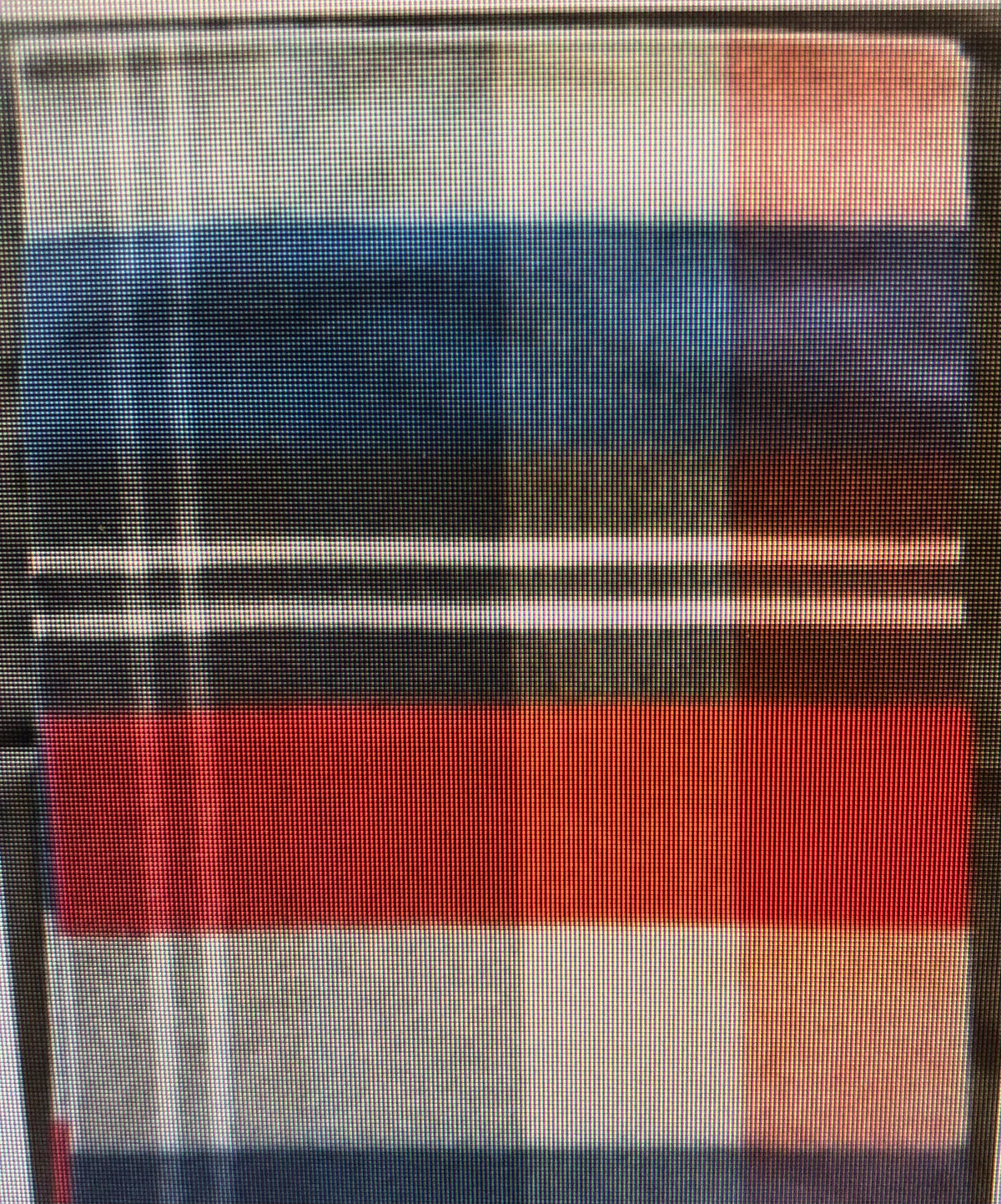 Close-up of a plaid knitting pattern for a scarf in blue, red, and white.