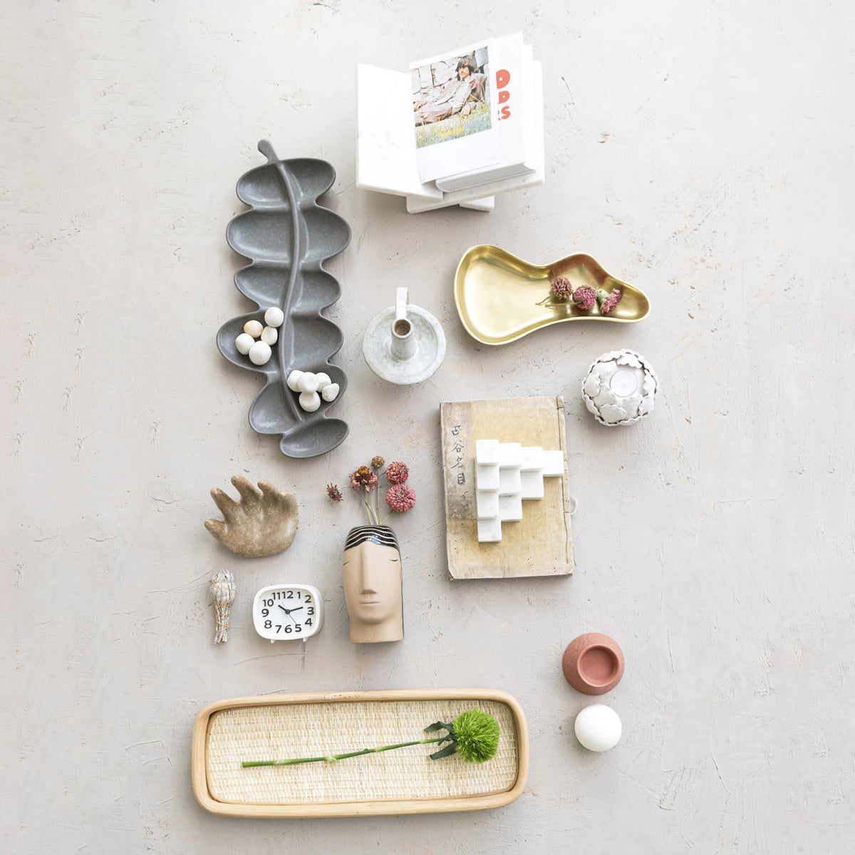 White interlocking marble book holder displayed among various decorative home accessories.