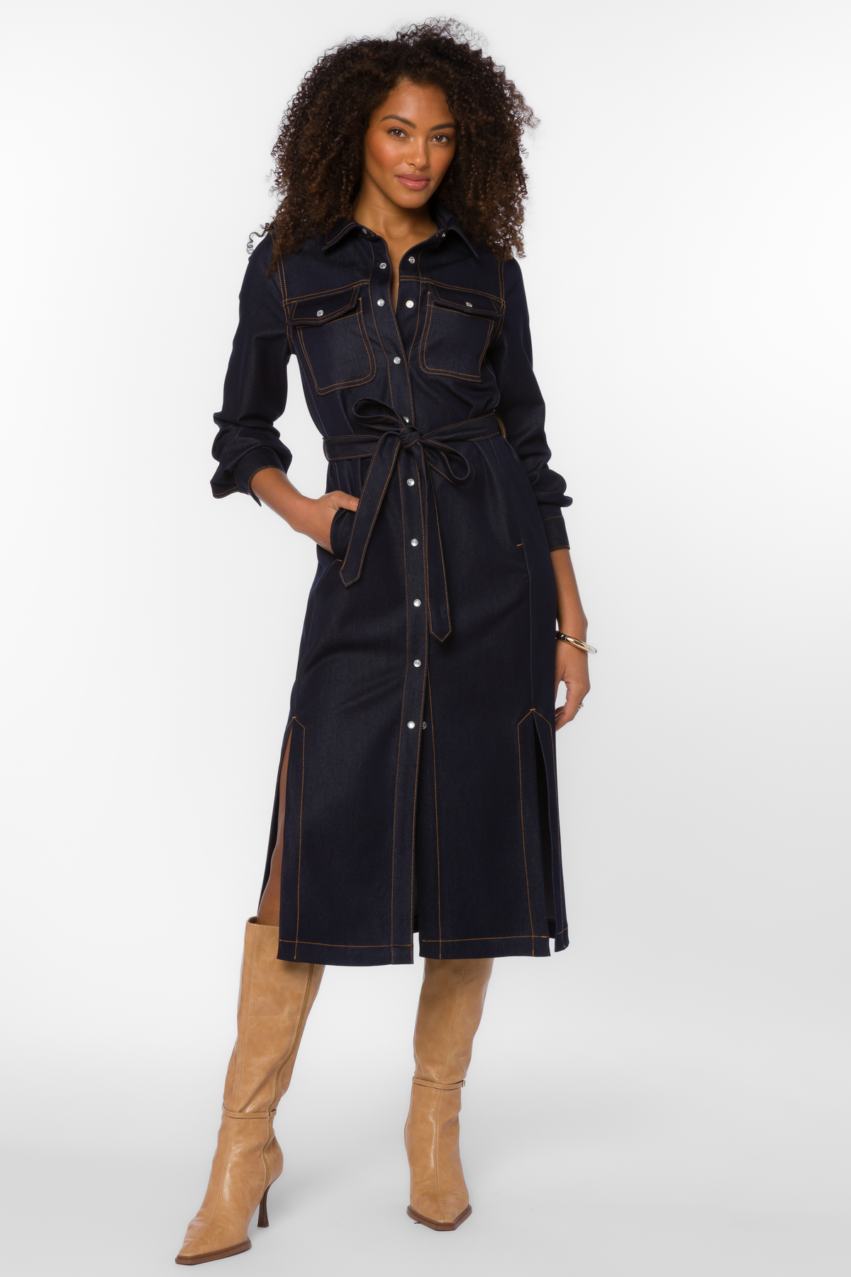 Woman wearing the Joanne Dress, a dark-wash indigo denim midi shirt dress with a self-tie belt.