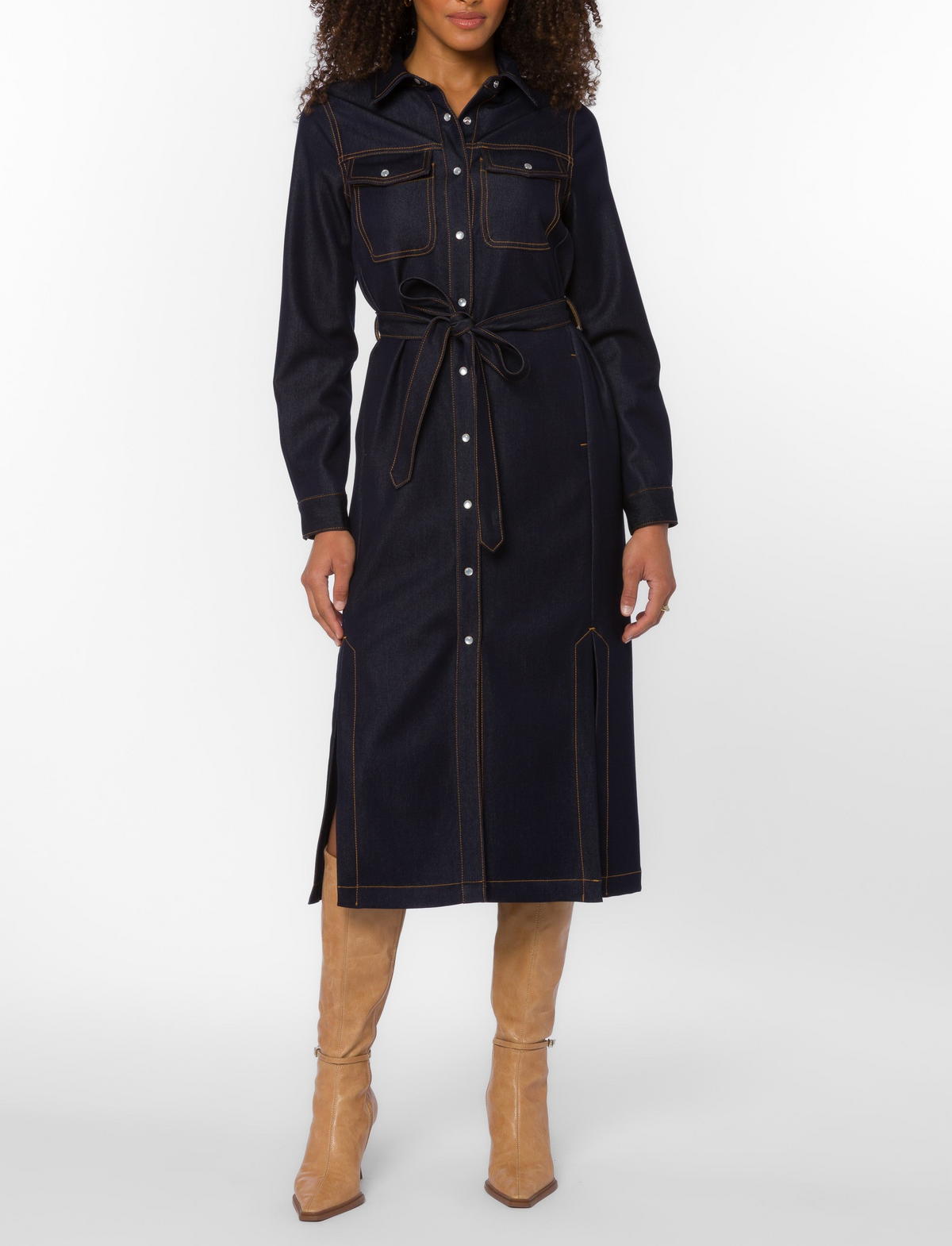 Woman wearing the Joanne Dress, a dark-wash indigo denim midi shirt dress with a self-tie belt.
