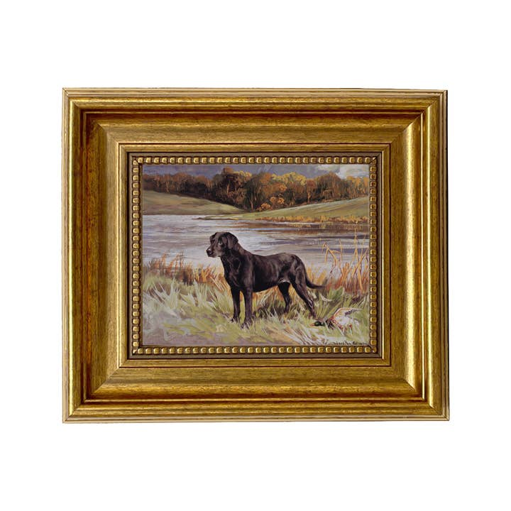 Framed painting print of a black Labrador Retriever with a duck by a lake in a gold wood frame.