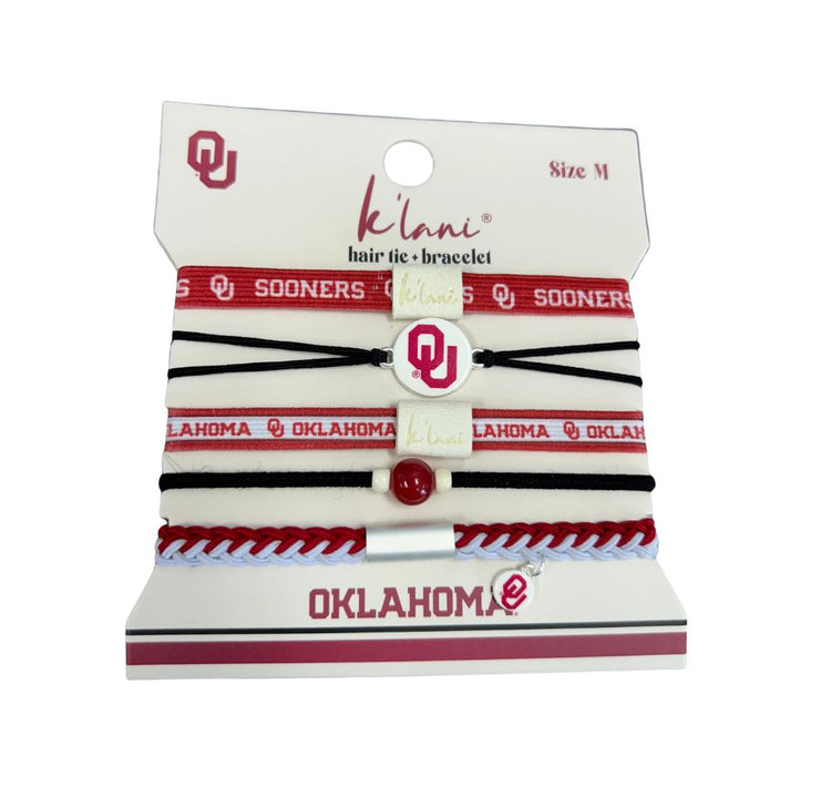 Set of five Oklahoma Sooners hair tie bracelets in red, white, and black on a display card.