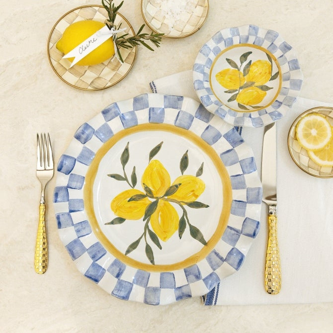 Ceramic cheese platter with a scalloped edge in light blue featuring white floral patterns.