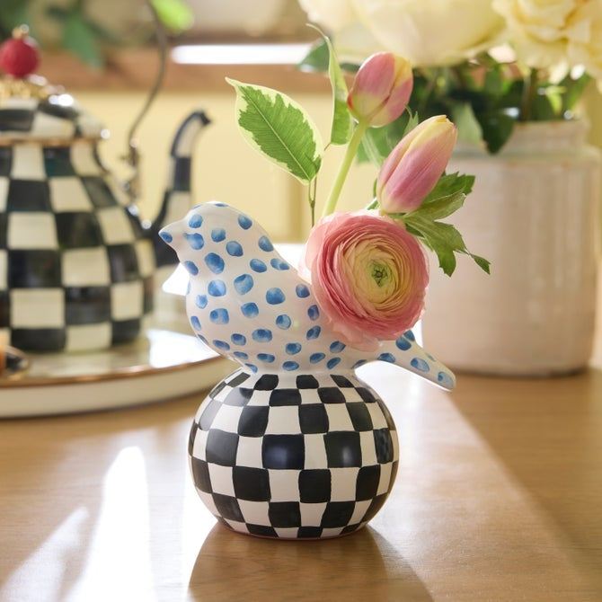 Hand-painted MacKenzie-Childs bird vase with blue dots and a black and white checkered base.