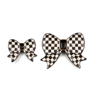 Set of two black and white checkered bow-shaped ceramic trinket dishes with gold accents.