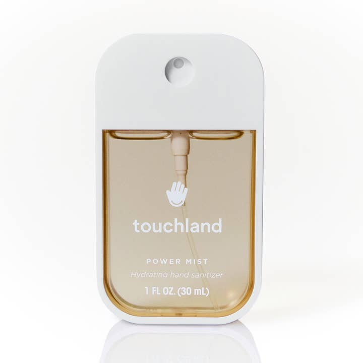 Midnight S'mores Power Mist Hand Sanitizer in a white spray bottle with light brown liquid.