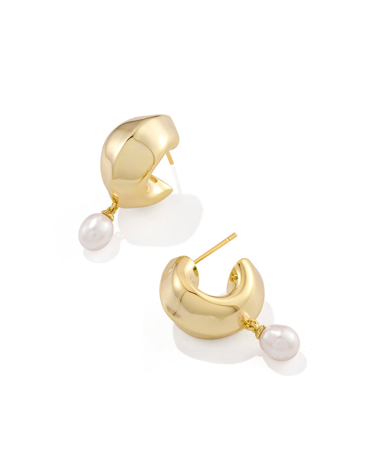 Oakland Pearl Huggie Earrings featuring chunky gold-tone hoops with dangling white pearls.