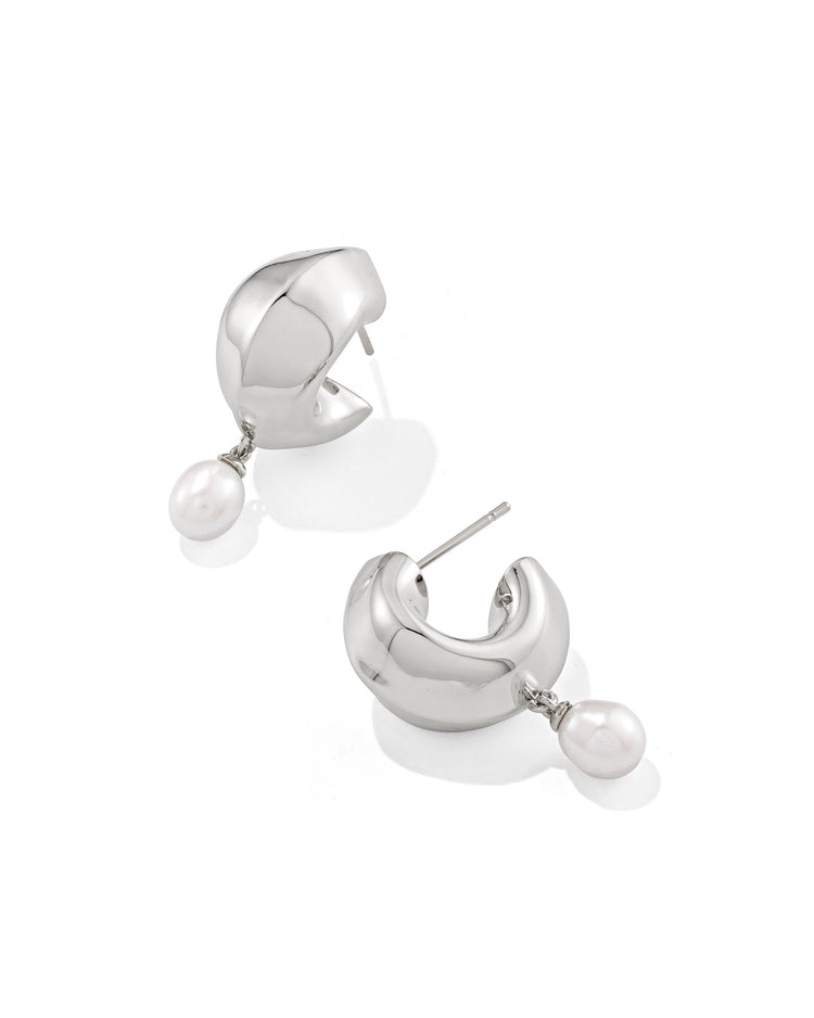 Silver Oakland Pearl Huggie Earrings featuring a chunky hoop design with a dangling white pearl.