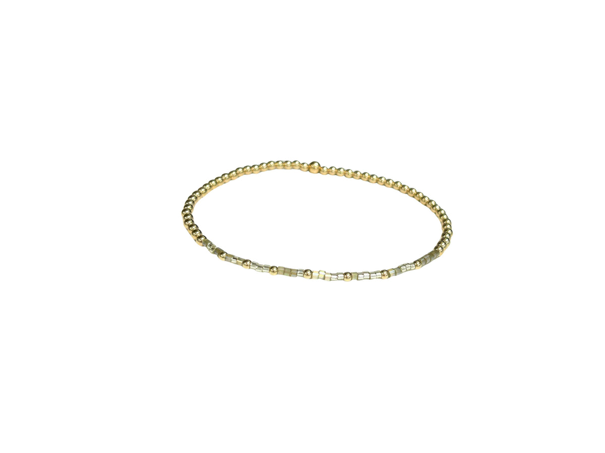 Gold-filled elastic bracelet featuring Morse code beads spelling Proverbs 31:25.