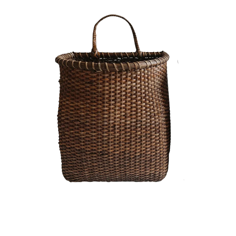 Woven dark brown rattan door basket with a single arched handle for hanging.