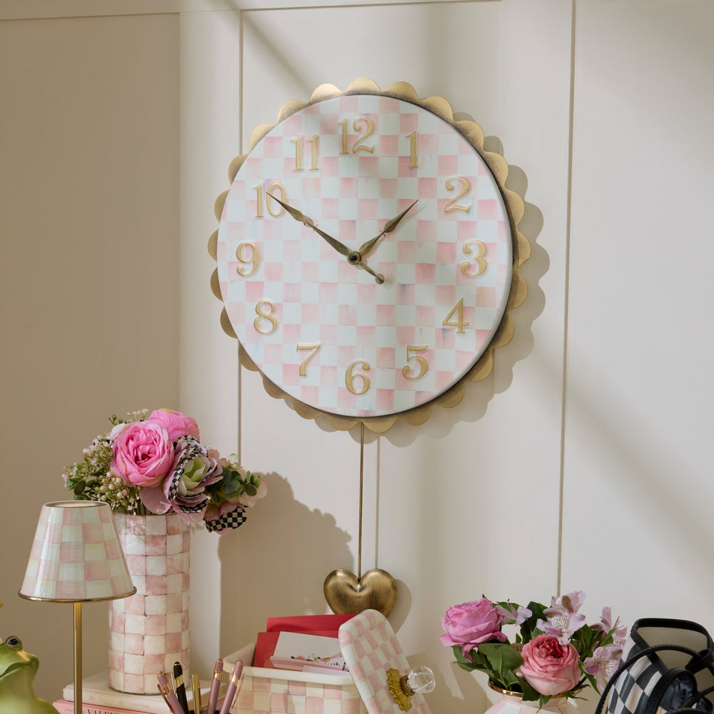 Rosy Check Heart Pendant Clock with pink checkered face, brass numbers, and heart-shaped pendulum.