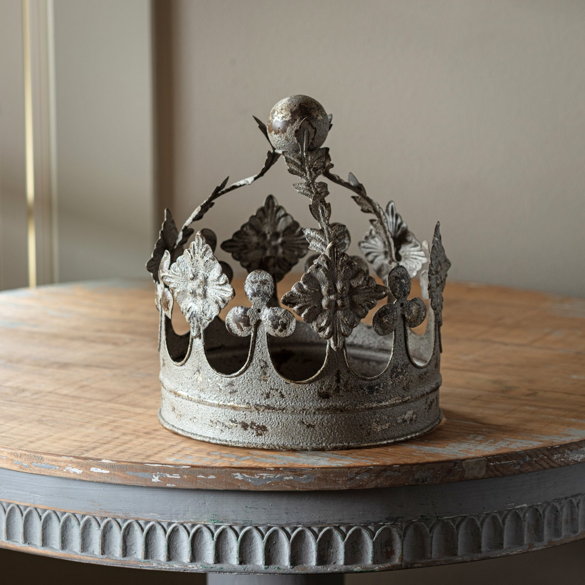 Royal Antiqued Crown made of metal with an aged gray finish on a rustic wooden table.