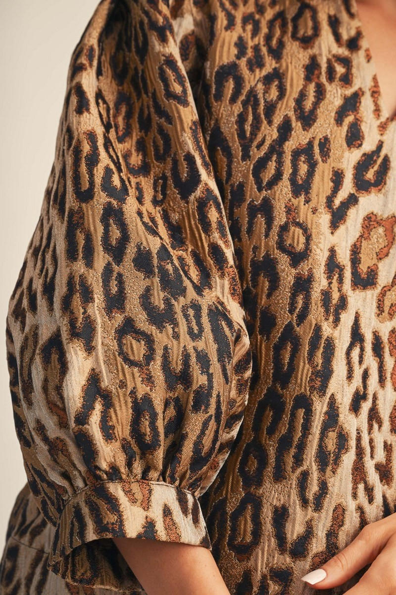 Close-up of the leopard jacquard fabric and puff sleeve on the Eliana Ruffled Neck Top.