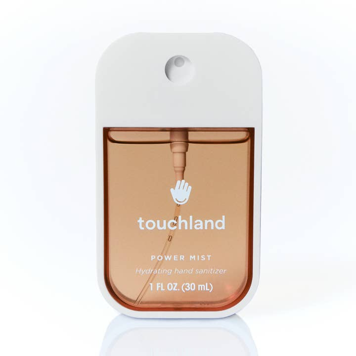 Salted Caramel Power Mist Hand Sanitizer in a white rectangular spray bottle with amber liquid.