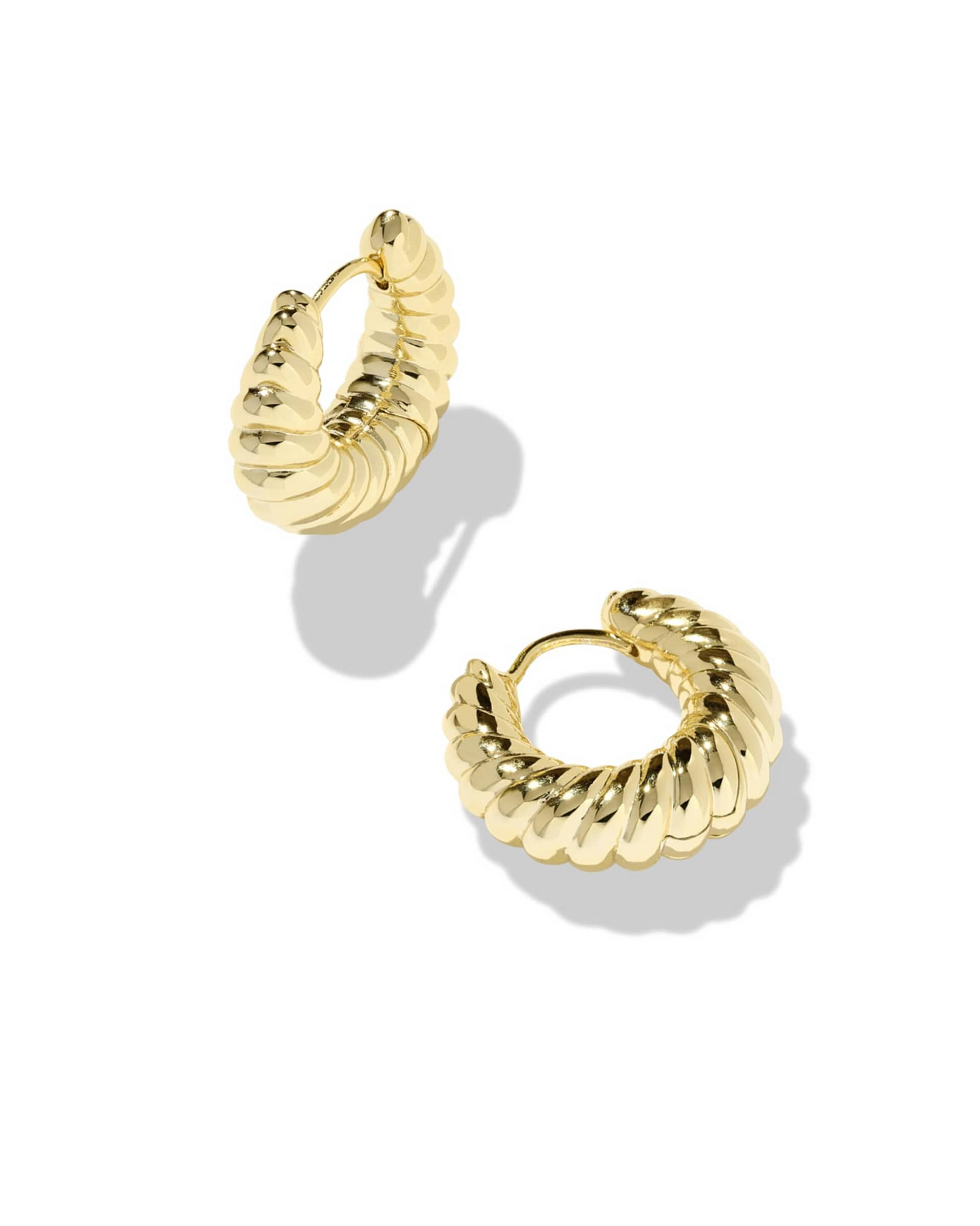 A pair of gold Sandy Huggie Earrings with a thick, sculptural ribbed texture.