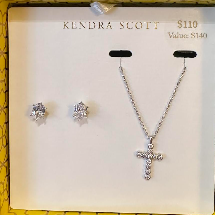 Kendra Scott gift set with silver cross pendant necklace and oval crystal stud earrings.