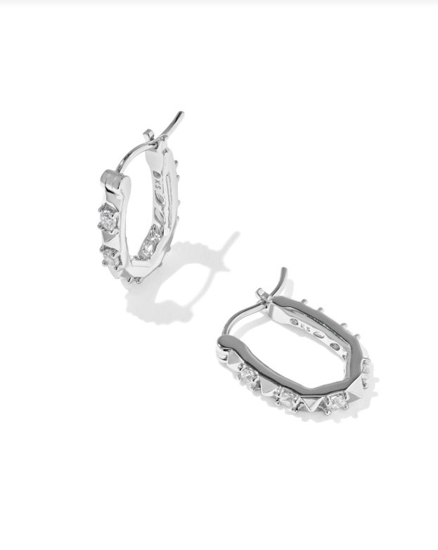 Fate Huggie Earrings in silver with small clear round-cut stones and geometric metal accents.
