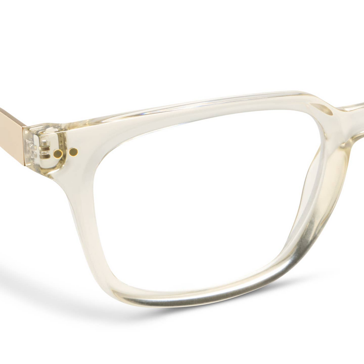 Close-up of Sidebar Blue Light Glasses in Fog, featuring clear square frames and gold metal temples.