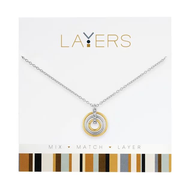 Silver layered necklace with gold accents featuring a trio ring pendant design.
