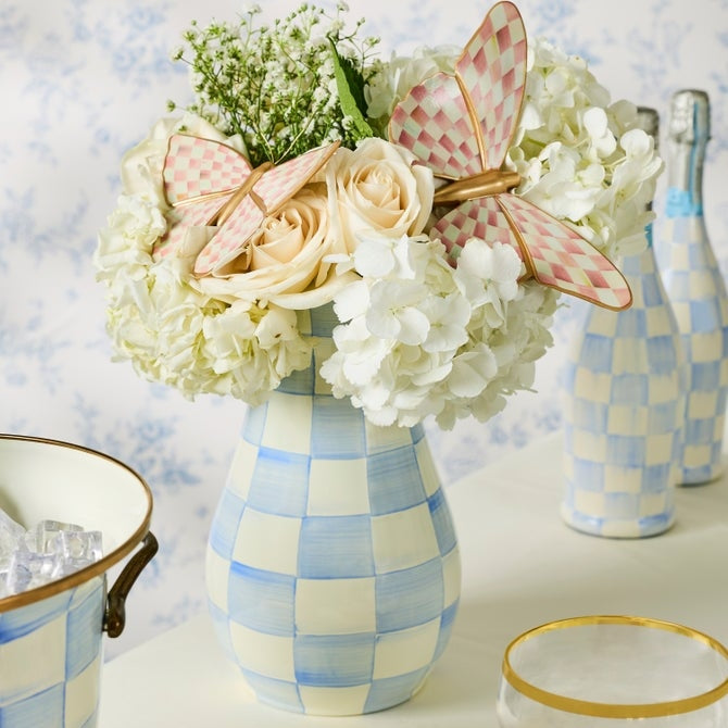 Tall enameled steel vase with hand-painted sky blue checks and a bronzed rim.