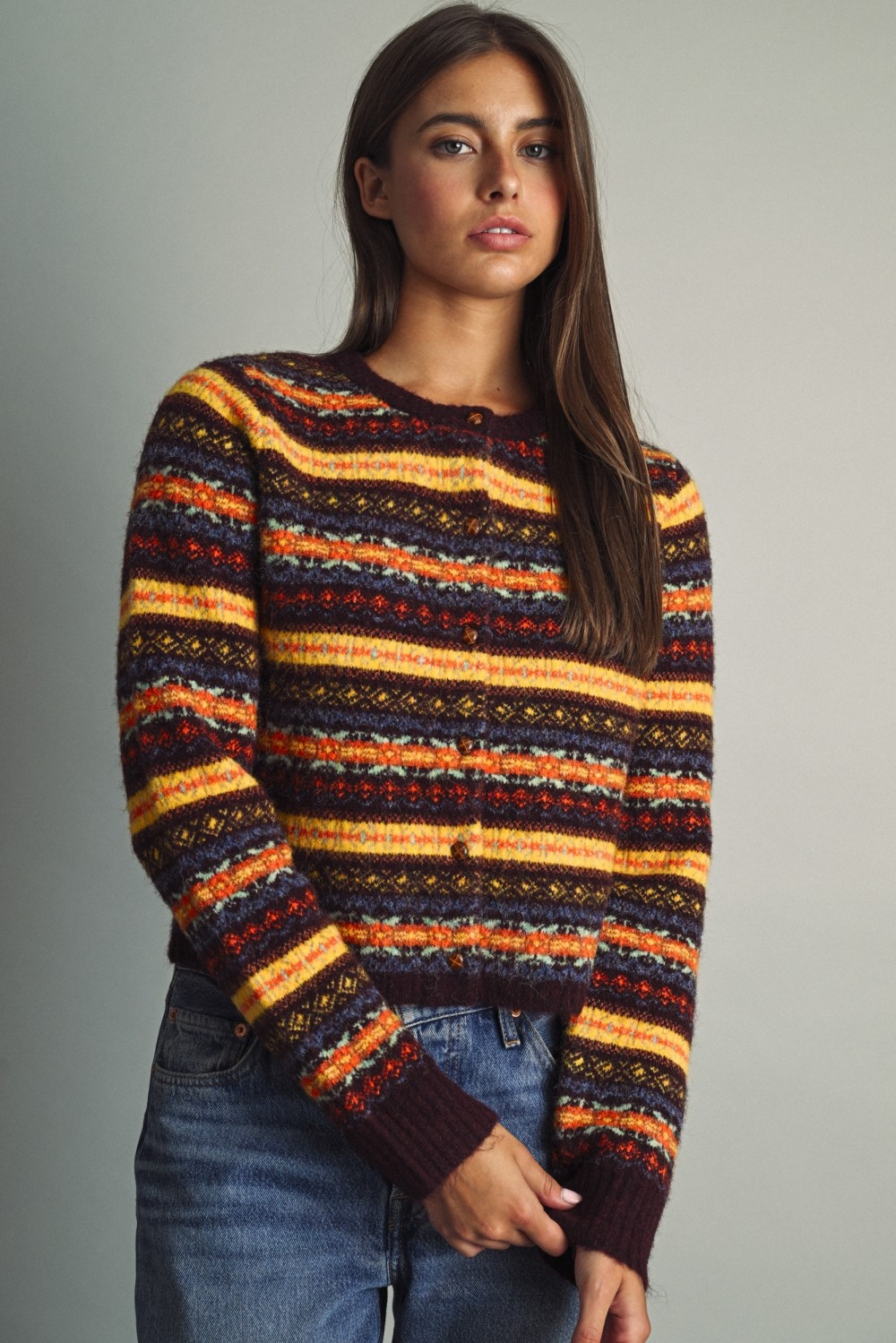 Althea multicolored Fair Isle pattern cropped knit cardigan with round neck and button front.