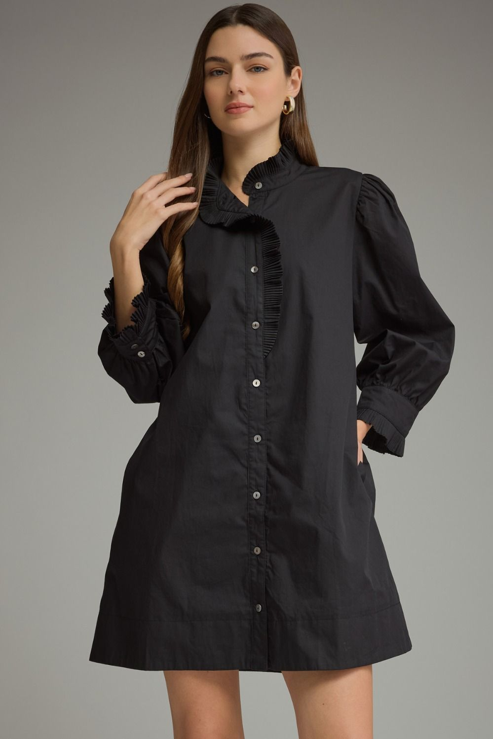 Agnes black mini dress with 3/4 puff sleeves, ruffled high neckline, and front button closure.